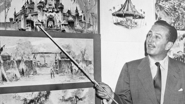 Walt Disney pointing at a storyboard