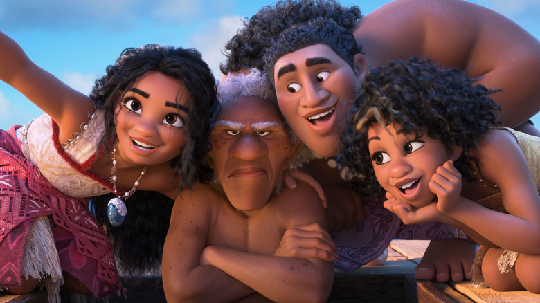 Moana and her team -- two of them happy, one of them grumpy -- smiling as if for a selfie.