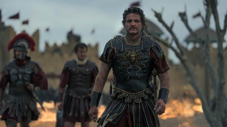 Pedro Pascal as Marcus Acacius in Gladiator II covered in filth after battle in Gladiator II