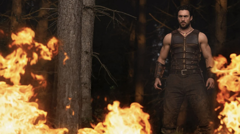 Kraven looks at a burning forest in Kraven the Hunter