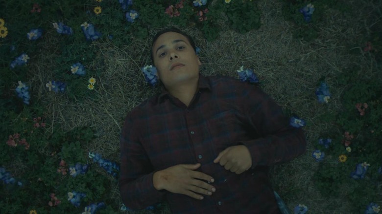 Frank Dillane's Nick laying in a field of flowers in the Fear the Walking Dead episode Gone Out Here