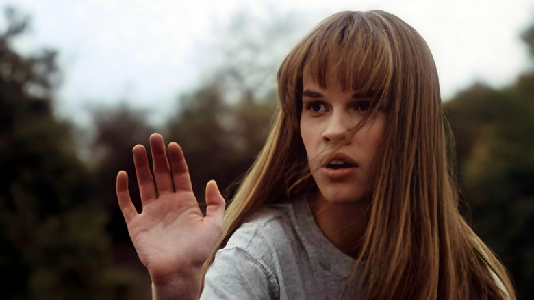 Julie Pierce with her hand raised in "The Next Karate Kid"