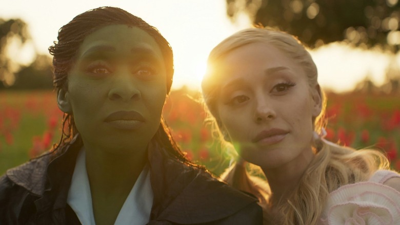 Cynthia Erivo's Elphaba and Ariana Grande's Glinda looking upward in Wicked