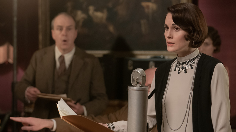 Kevin Doyle and Michelle Dockery prepping sound equipment in Downton Abbey: A New Age