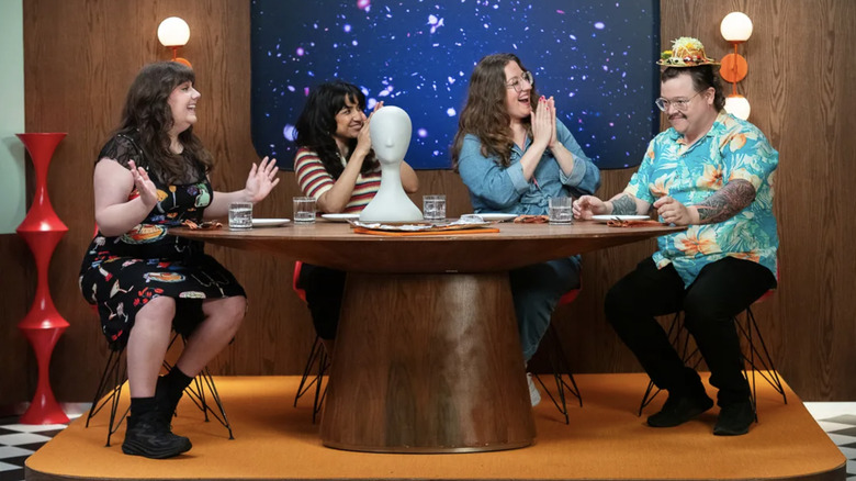 Jordan Myrick, Rekha Shankar, Jess Ross, and Luke Field wearing an edible hat on Gastronauts