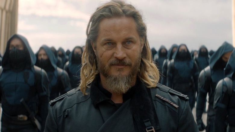 Travis Fimmel as Desmond Hart, standing with soldiers in Dune: Prophecy