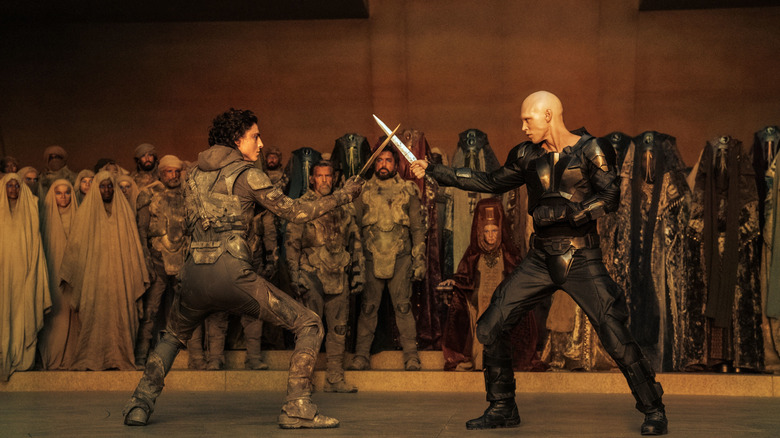 Paul Atreides and Feyd-Rautha Harkonnen facing each other with blades drawn