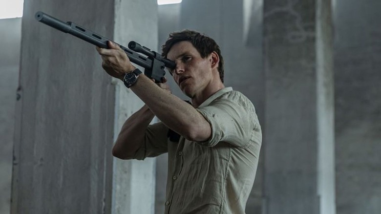 Eddie Redmayne brandishes a rifle as The Jackal