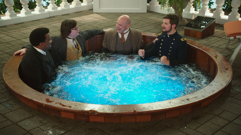 Adam, Jacob, Nick, and Lou, fulled dressed in Civil War-era clothing, sitting in a hot tub.