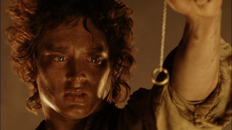 Dirt-covered Frodo looks at ring