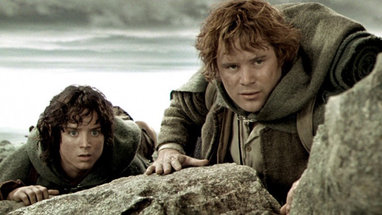 Frodo Sam crouch behind rocks