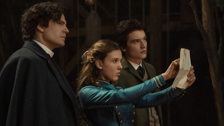 Henry Cavill, Millie Bobby Brown, and Louis Partridge in Enola Holmes 2