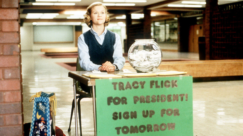 Tracy Flick Sits With Sign