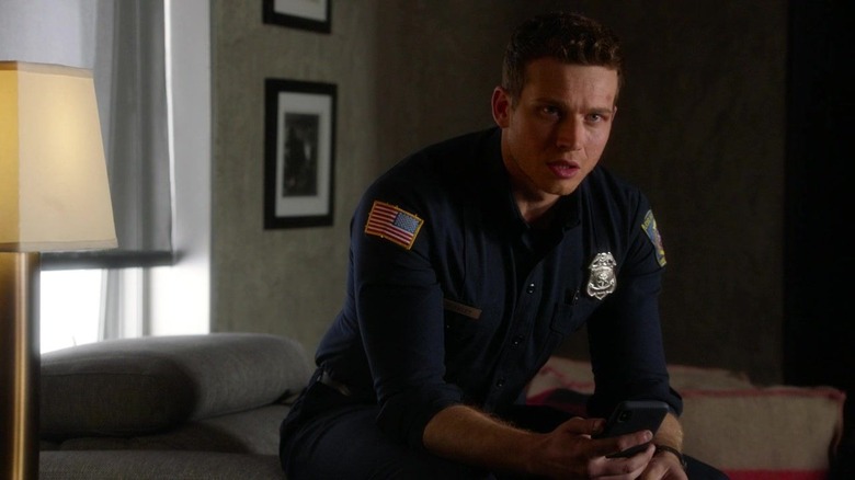 Buck sitting in firefighter uniform holding phone