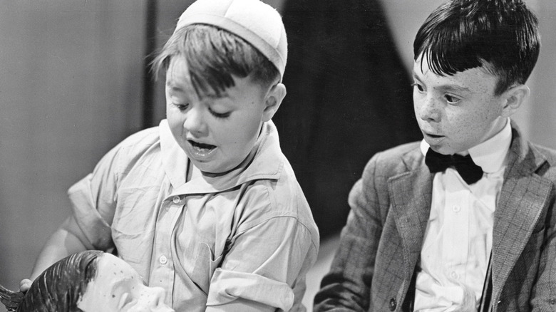 Spanky and Alfalfa admire a clay recreation of Alfalfa's head in The Little Rascals