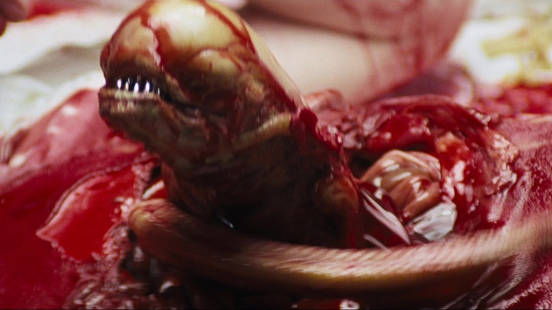 Chestburster from Alien crawling out of Kane's bloody chest cavity