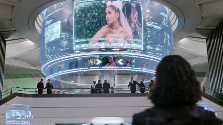 An alien surveillance monitor displaying Ariana Grande on the red carpet in Men in Black: International