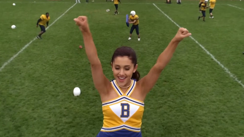 Ariana Grande as Amanda cheering on a football in Swindle