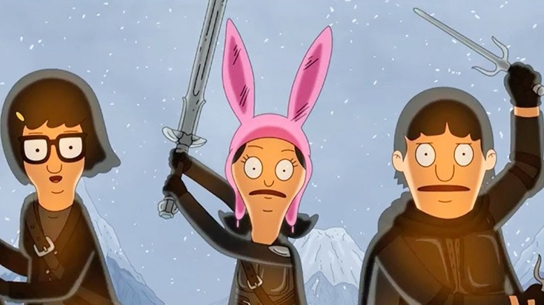 Louise, Tina, and Gene brandish weapons on a snowy mountainside