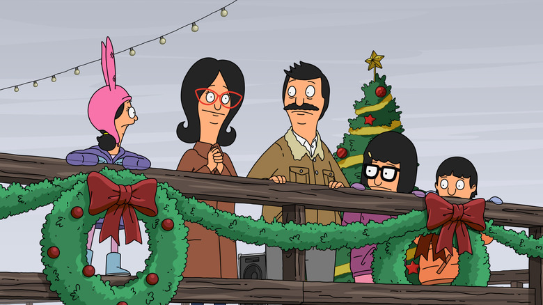 The Belcher family stands on a pier covered in Christmas decorations