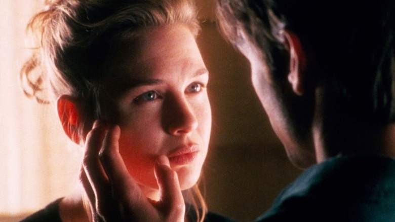 Renée Zellweger with Tom Cruise's hand on her face