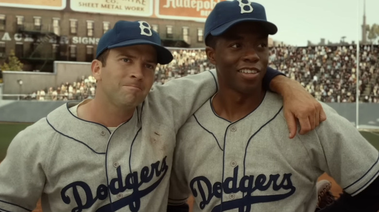 Pee Wee Reese (Lucas Black) puts arm around Jackie Robinson (Chadwick Boseman) in 42