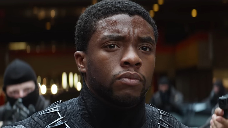 Chadwick Boseman as T'Challa, The Black Panther, surrounded by armed soldiers in Captain America: Civil War