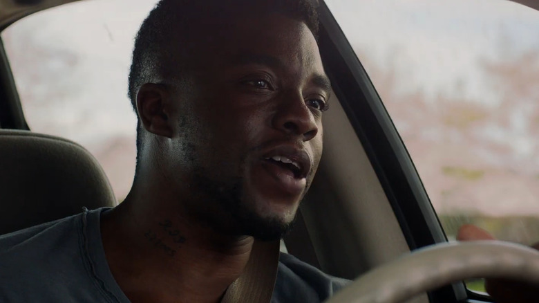 Chadwick Boseman as Vontae Mack, driving a car in Draft Day