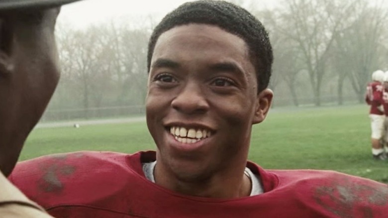 Chadwick Boseman as Floyd Little smiling in The Express: The Ernie Davis Story