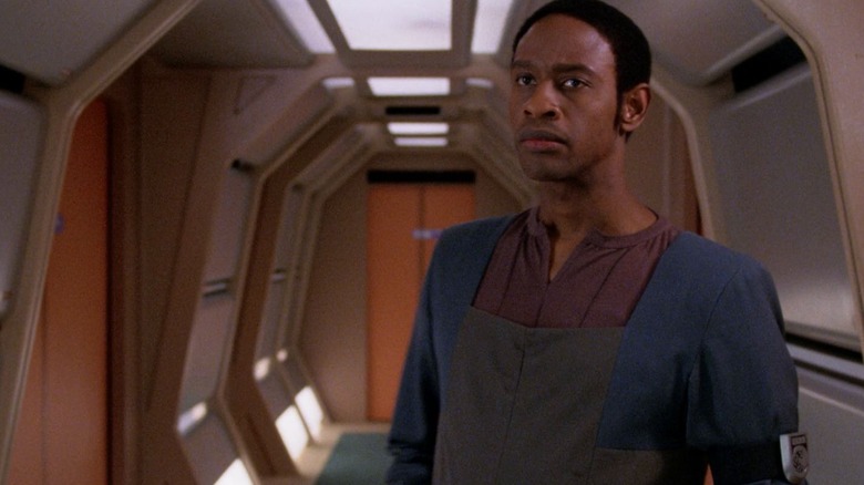 Devore, holding a laser, in a hallway of the U.S.S. Enterprise on Star Trek: The Next Generation