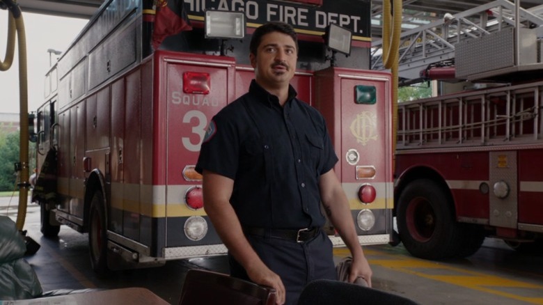 Chicago Fire's Otis in front of a fire truck