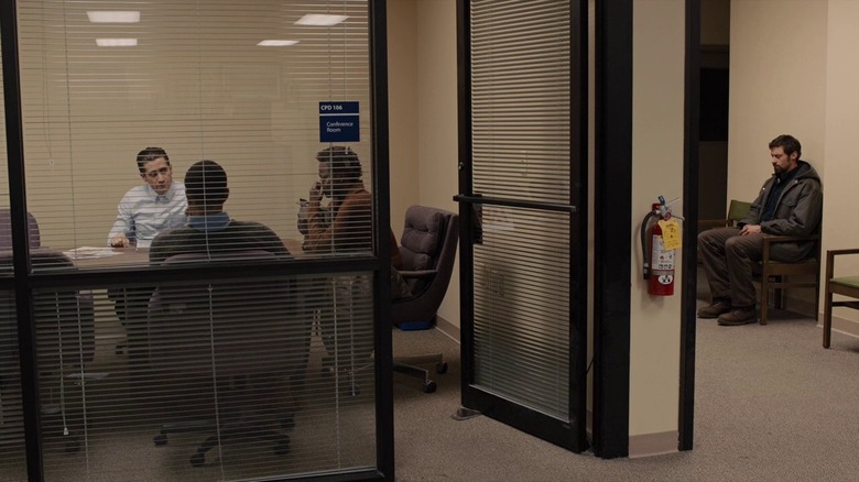 Hugh Jackman's Keller Dover sits outside a room in Prisoners