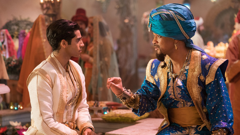 Aladdin (Mena Massoud) listening to the Genie (Will Smith) in Aladdin