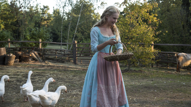 Cinderella (Lily James) feeding animals in Cinderella