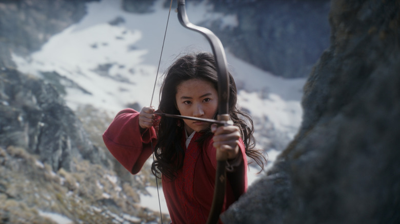 Mulan (Liu Yifei) aims bow and arrow in Mulan