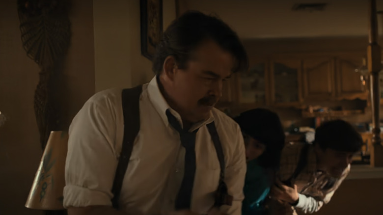 An agent shielding kids in Stranger Things