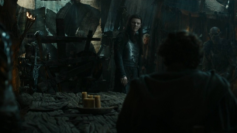 Adar faces Elrond across table