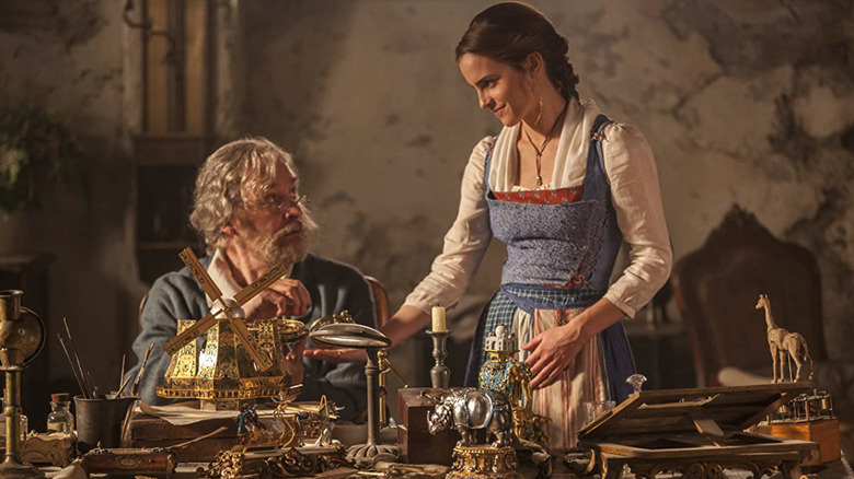 Belle standing at her father Maurice's desk