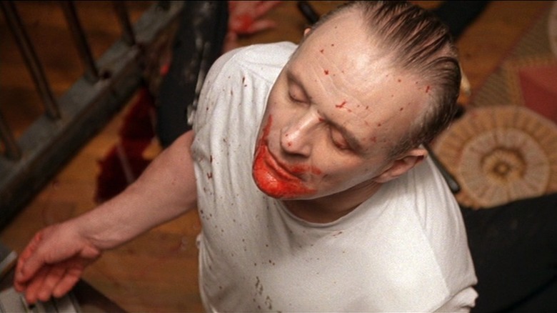 Anthony Hopkins as Hannibal Lecter with blood splattered on his face in The Silence of the Lambs