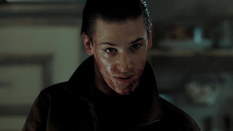 Gaspard Ulliel as Hannibal Lecter with blood splattered around his mouth in Hannibal Rising