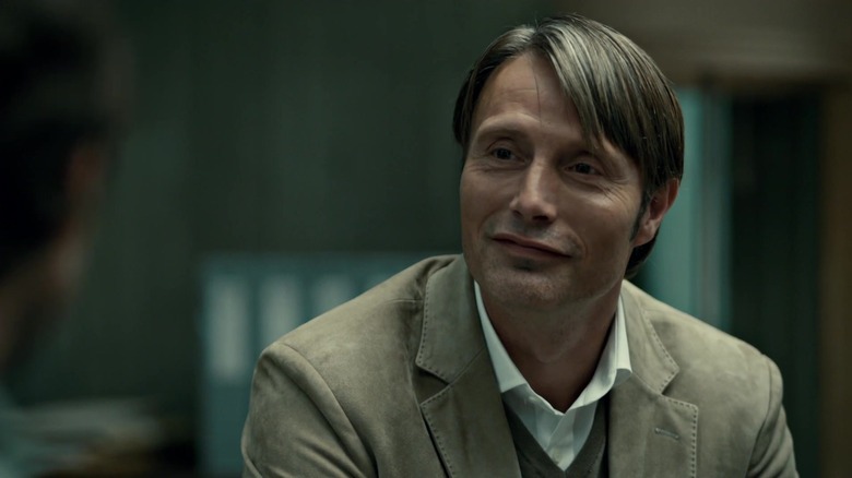 Mads Mikkelsen as Hannibal Lecter smiling on Hannibal