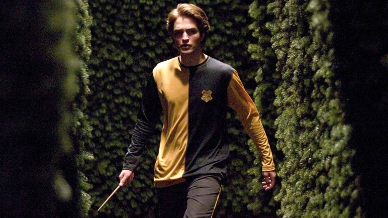 Robert Pattinson holding wand