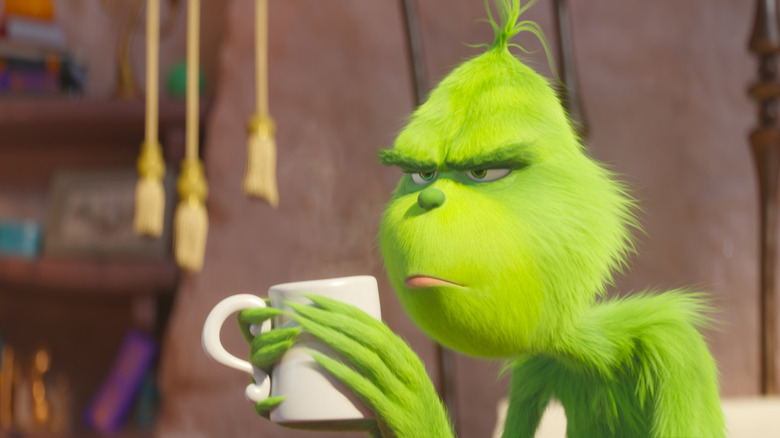 The Grinch nursing a cup of coffee