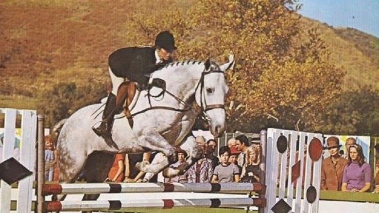 A girl on a horse in The Horse in the Gray Flannel Suit