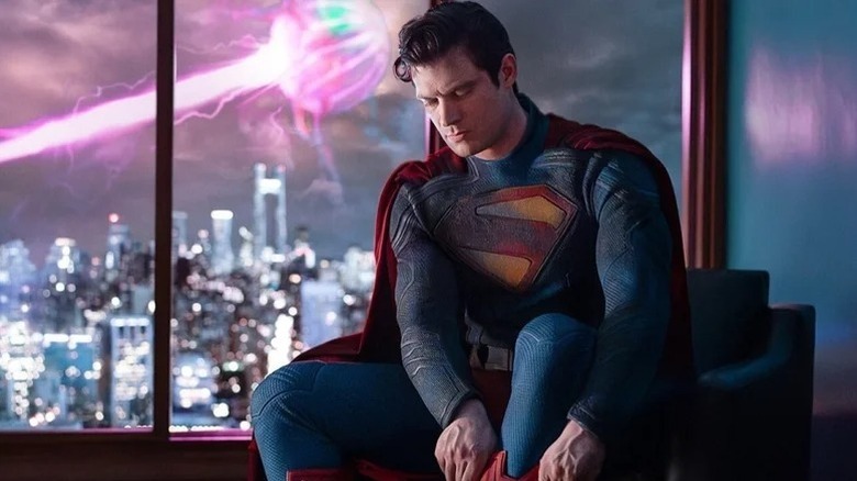 David Corenswet as Superman putting on his boots in a promo picture