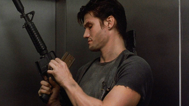 Dolph Lundgren as The Punisher holding a gun in an elevator