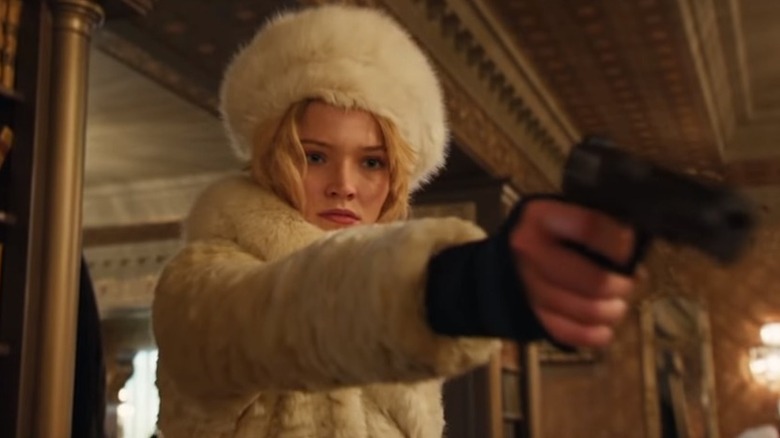 Sasha Luss points gun in ANNA