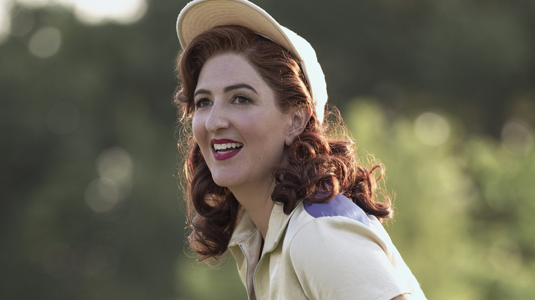 D'Arcy Carden waving and smiling in A League of Their Own