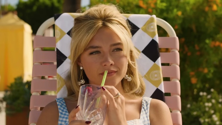 Alice Chambers drinking a cocktail by the pool