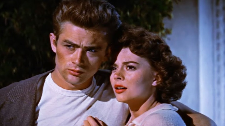 Jim holds Judy and looks concerned in the film 